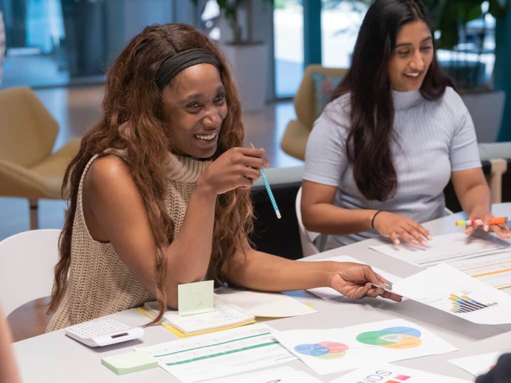 An image of a woman smiling in a work setting.