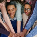 Women pledging hands