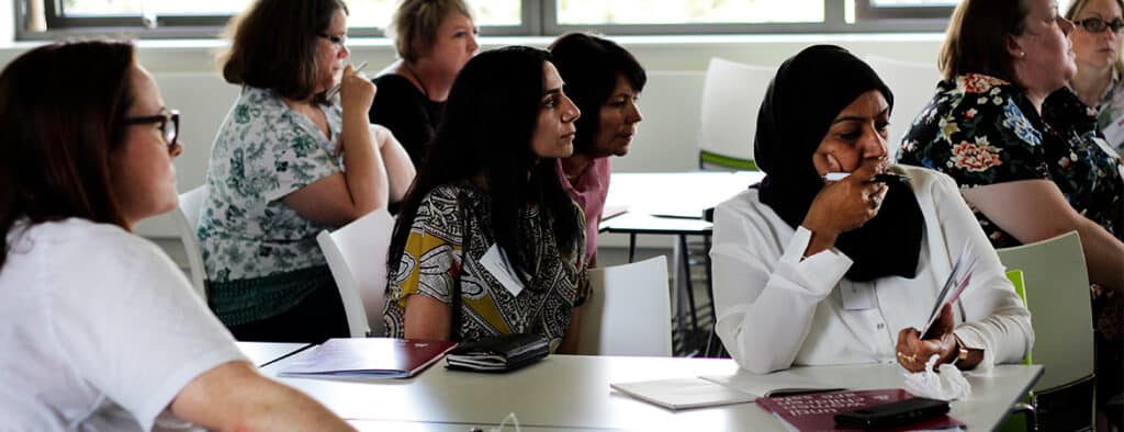 Women sitting around desks and working