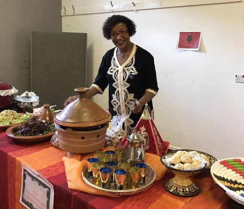 Woman standing at table with food
