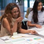 Women smiling working together at a desk