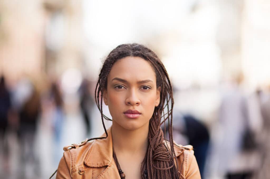Woman looking into camera with a blurred background