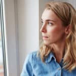 Woman looking out of window