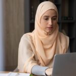 Woman sitting at a desk working on a laptop