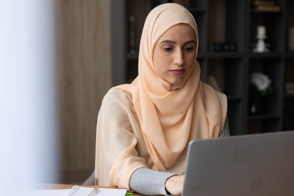 Woman sitting at a desk working on a laptop