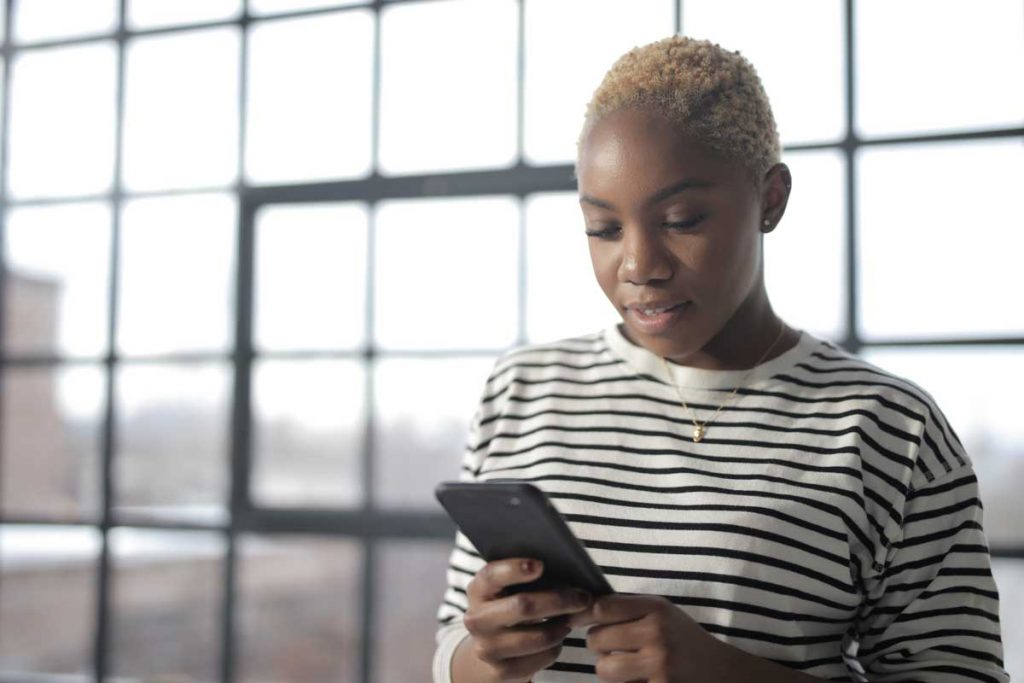 Woman looking down at mobile phone