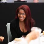 A woman smiling attending Women's Aid's National Conference 2023