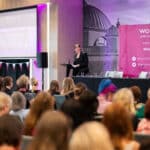 Woman talking to audience at a Women's Aid conference