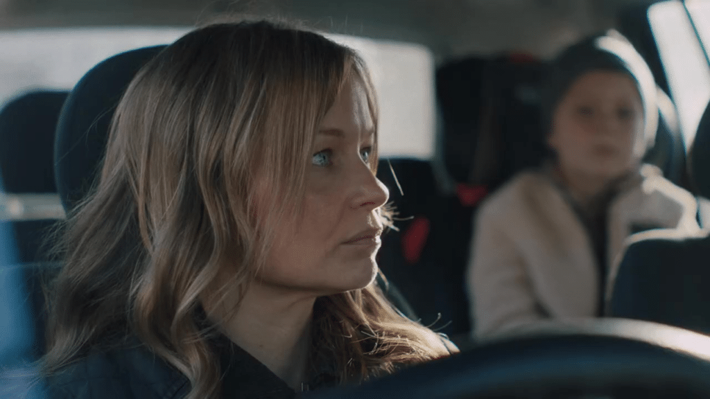 Woman in a car with child in the backseat