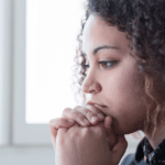 Women looking down leaning on hands